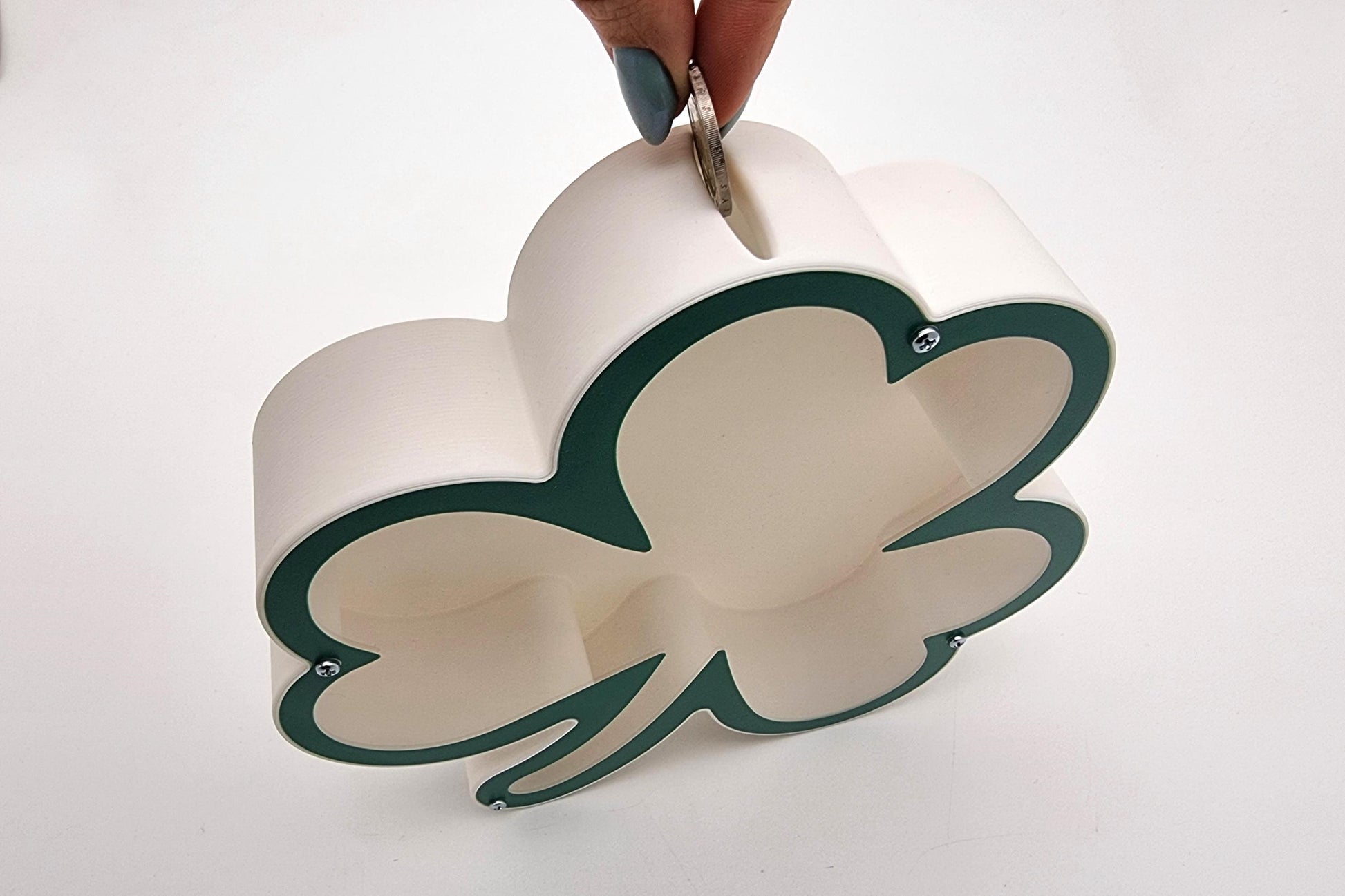 3D printed shamrock piggy bank in green and white, perfect for teaching kids about saving money.