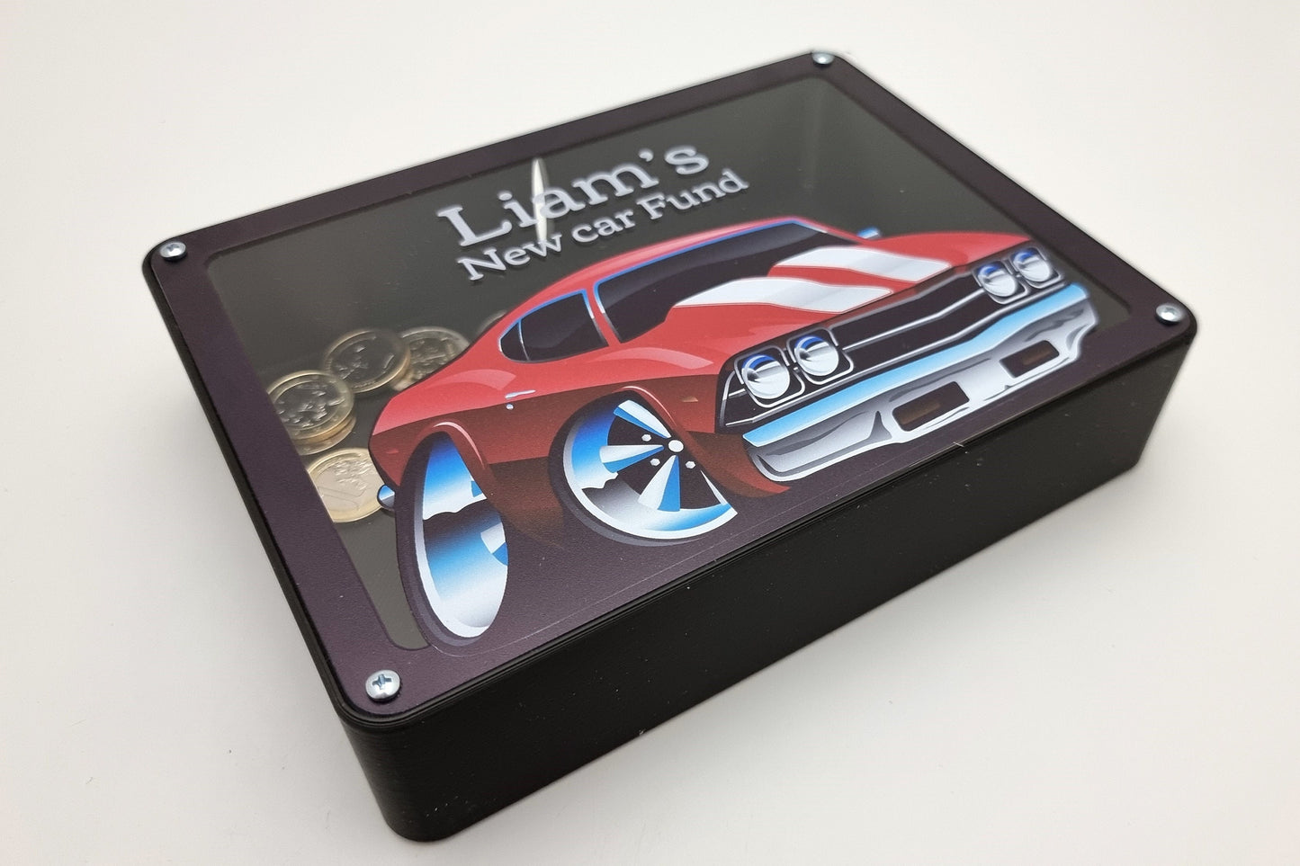 Personalized car piggy bank with Liam's name, displayed on a table with coins