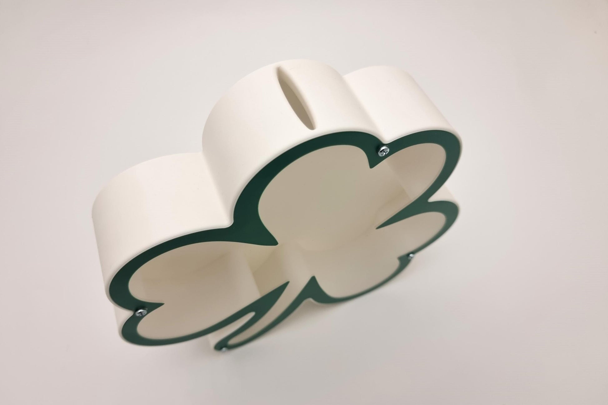 Side view of a personalized shamrock-shaped piggy bank, made of eco-friendly PLA plastic.