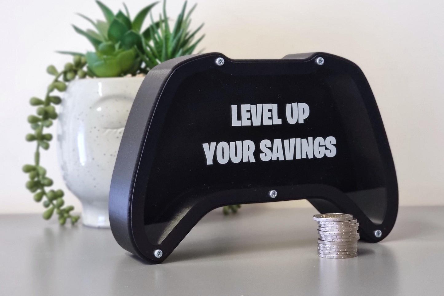 Gaming controller piggy bank with phrase Level up your savings - Perfect gift for gaming lovers!